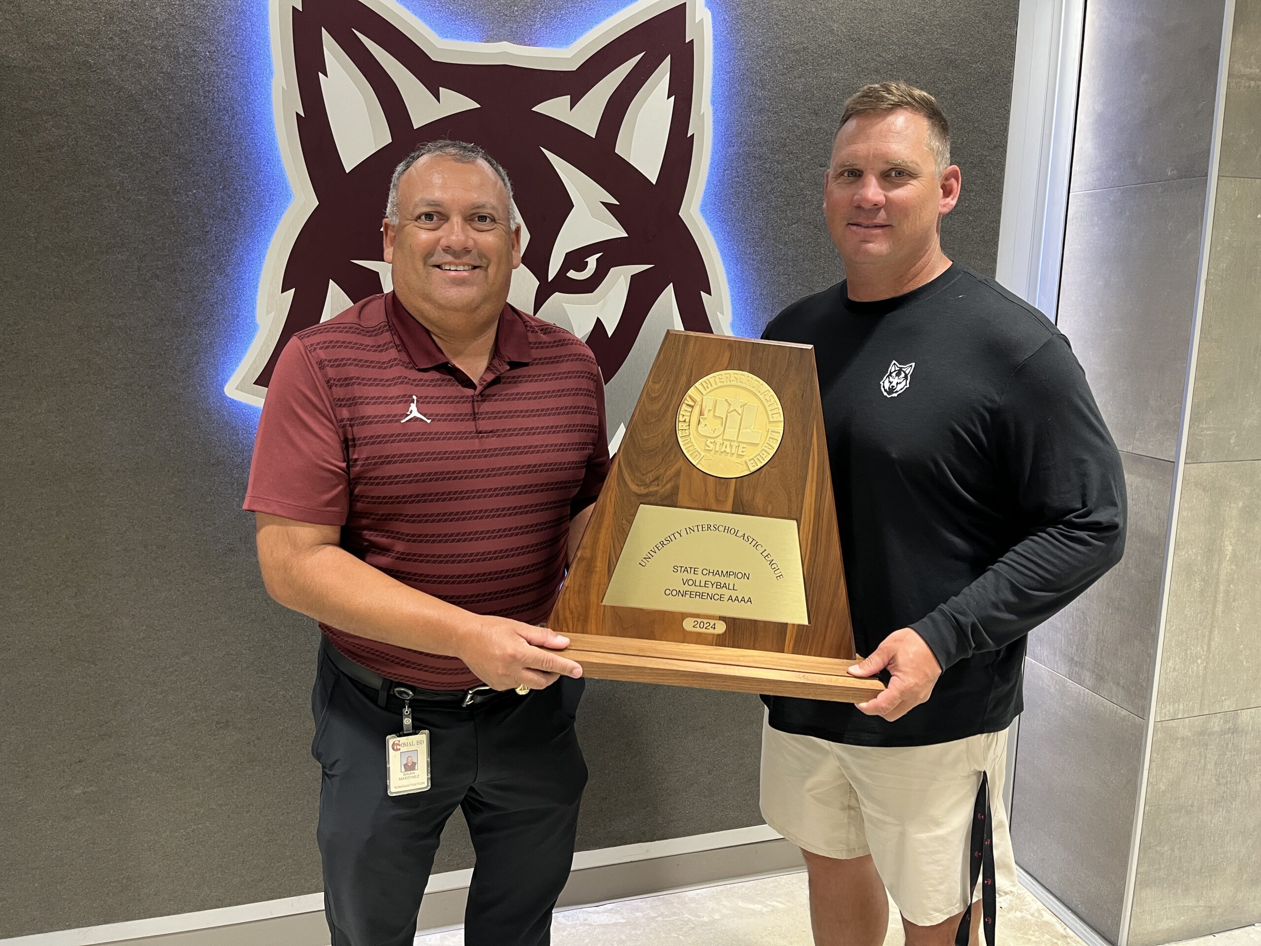 JD Zimmerhanzel & Brian Martinez pose with SA Davenport's 2024 volleyball state title trophy.